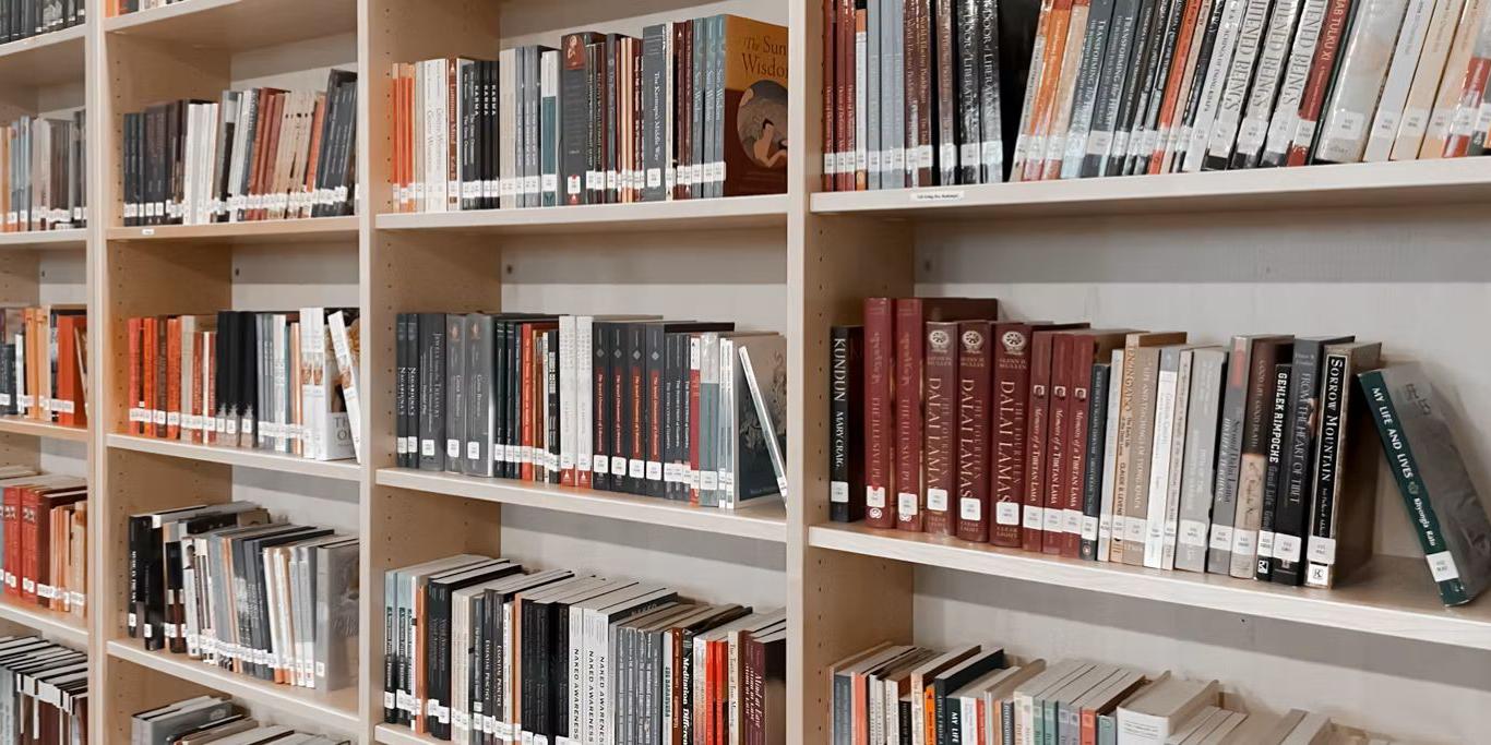 Buddhist library in the UK with shelves full of religious dharma books.