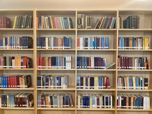 Buddhist library with shelves full of dharma texts and books.