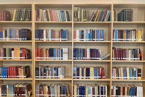 Buddhist library with shelves full of dharma texts and books.