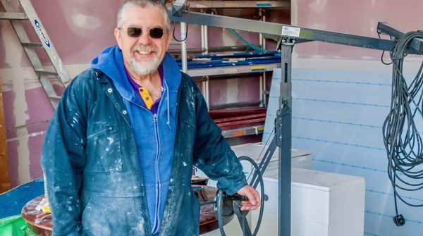 Decorator volunteer opportunity Man in blue clothes while decorating as a voluntary job at Buddhist Centre.