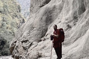 Khenpo Tokpa Tulku teacher Tibetan Buddhism trekking in the mountains.