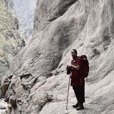 Khenpo Tokpa Tulku teacher Tibetan Buddhism trekking in the mountains.