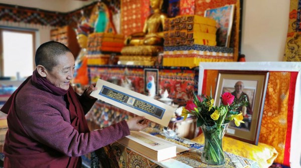 Tibetan Buddhist monk Lama Oser showing the Longchenpa text - Buddhism.