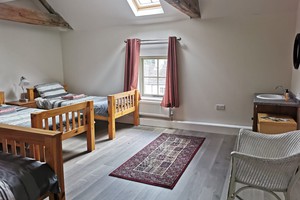 Dormitory room with four beds in the Coach House for voluteers and retreatants.