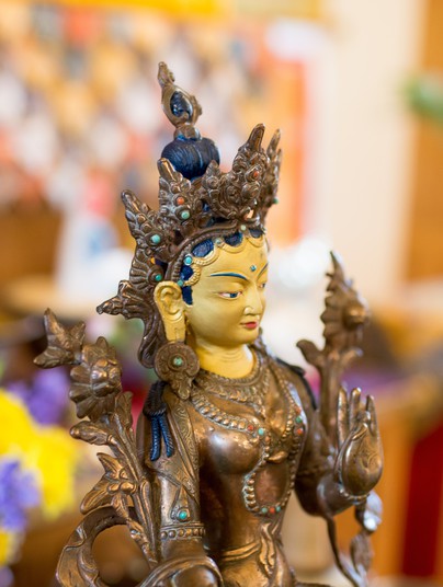 Golden statue of Tara, Buddhist deity of compassion in action.