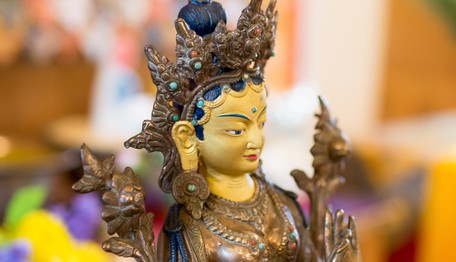 Golden statue of Tara, Buddhist deity of compassion in action.