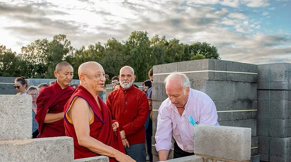 Buddha Temple UK Buddhist monk and several men doing building works for Buddha Temple in Yorkshire, England, UK.