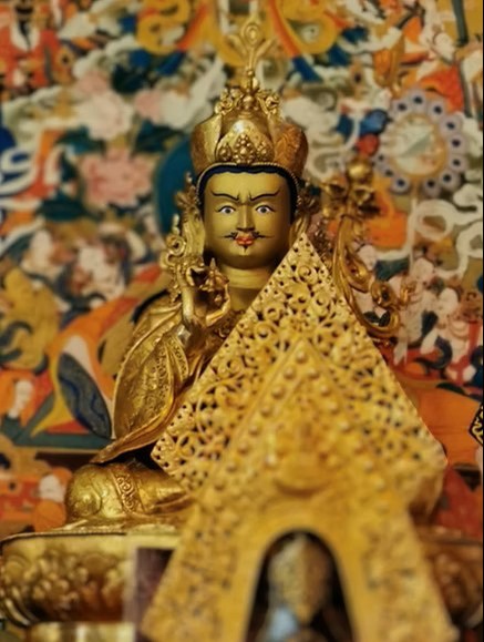 Buddhist meditation practice Tibetan Buddhist golden statue of Guru Rinpoche, or Padmasambhava.