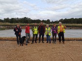 Group of volunteers with big smiles celebrating the foundation of the new Buddhist temple in Doncaster.